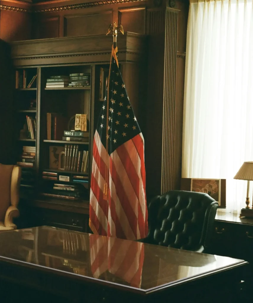 A lawyer's office featuring vintage wooden furniture and a U.S. flag at the center.