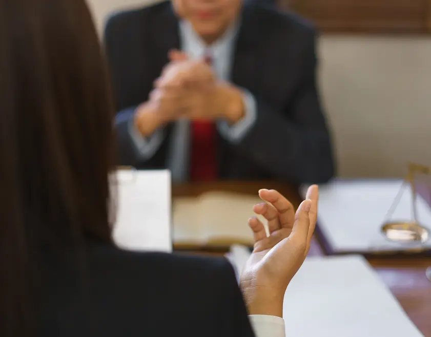 Back view of a conversation happening between attorney and client
