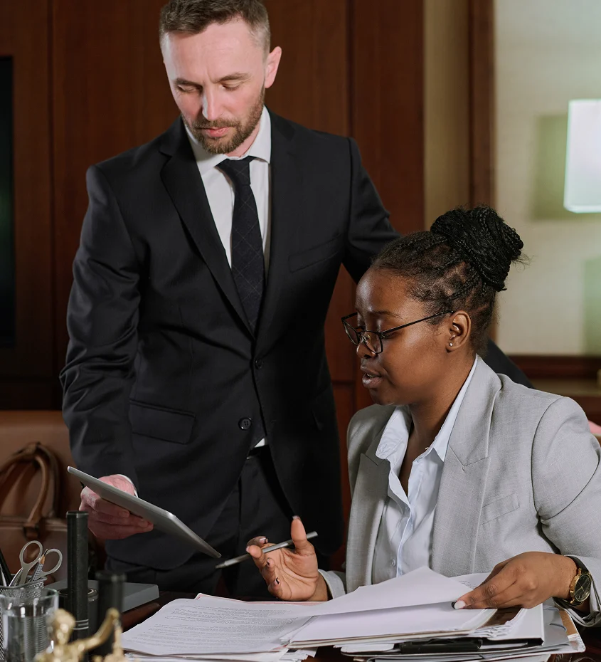 Attorney reviewing legal documents with a client in an office, discussing paperwork during a legal consultation.