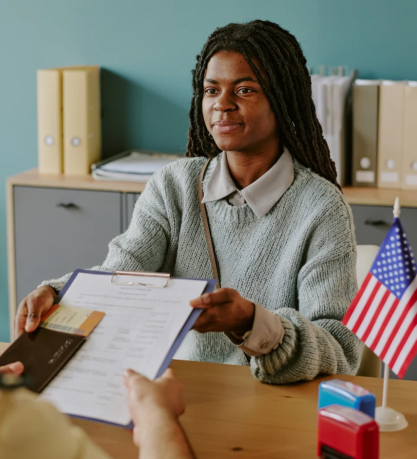 Black woman reviewing immigration documents in a U.S. office